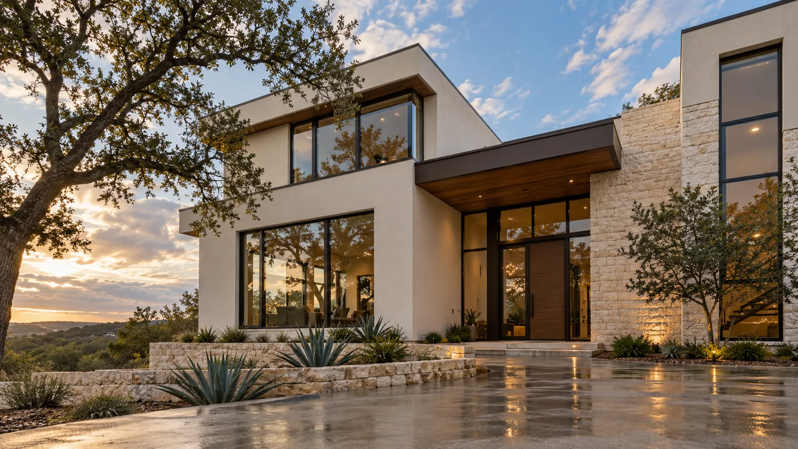 A modern stucco and limestone Austin home with slim dark bronze aluminum windows after rain at sunset